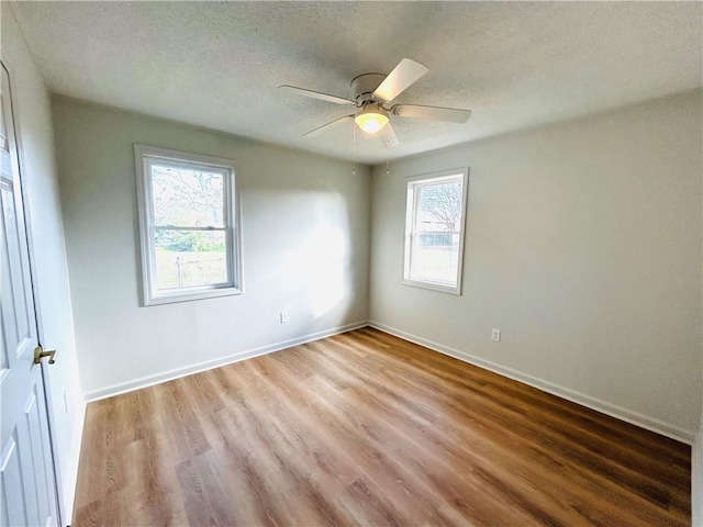 spare room featuring a textured ceiling, hardwood / wood-style flooring, and ceiling fan