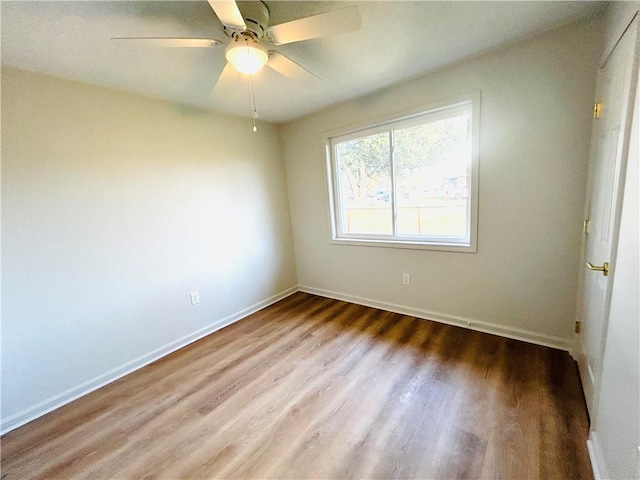 spare room featuring wood-type flooring and ceiling fan