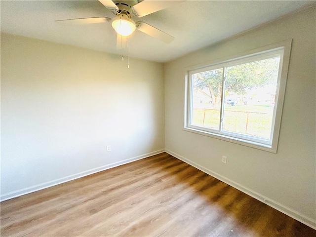 unfurnished room featuring light hardwood / wood-style floors and ceiling fan