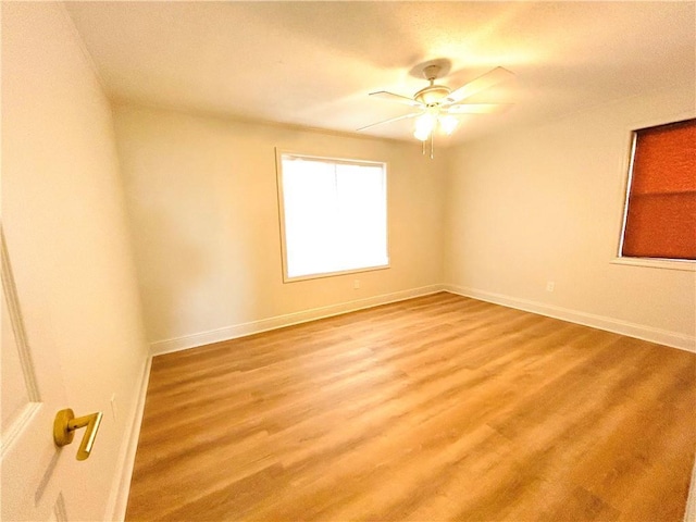 empty room featuring ceiling fan and light hardwood / wood-style flooring