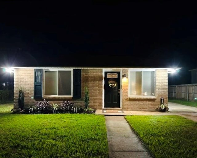 view of front of home with a lawn