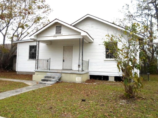 bungalow-style house with a porch and a front yard