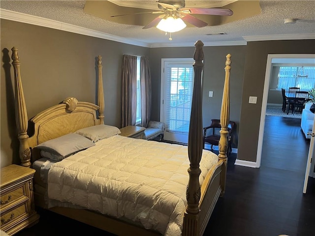 bedroom featuring ceiling fan, hardwood / wood-style floors, a textured ceiling, and ornamental molding