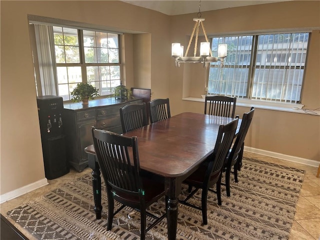 dining room with a chandelier and light tile patterned floors