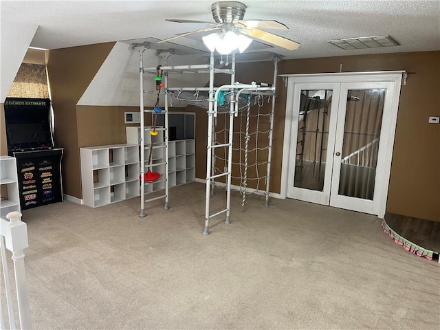 carpeted bedroom featuring ceiling fan, a textured ceiling, and french doors