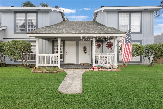 view of front of home featuring a front yard and a porch