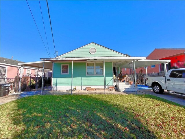 view of front facade with a front lawn and a carport