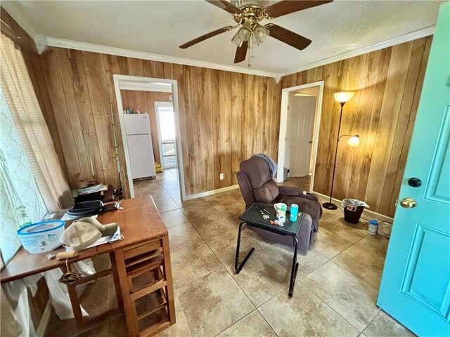 interior space featuring ceiling fan and crown molding