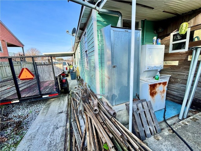 exterior space featuring stacked washing maching and dryer