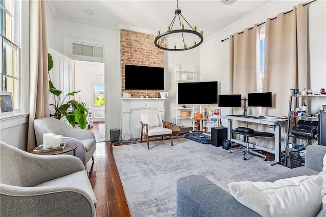 interior space with a fireplace, ornamental molding, a chandelier, and dark wood-type flooring