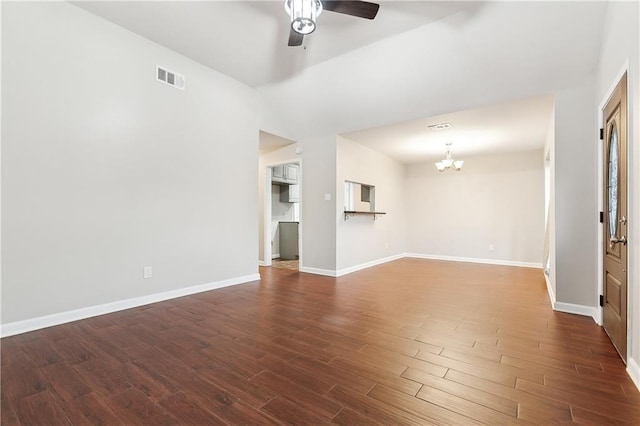 unfurnished living room with dark hardwood / wood-style floors and ceiling fan with notable chandelier