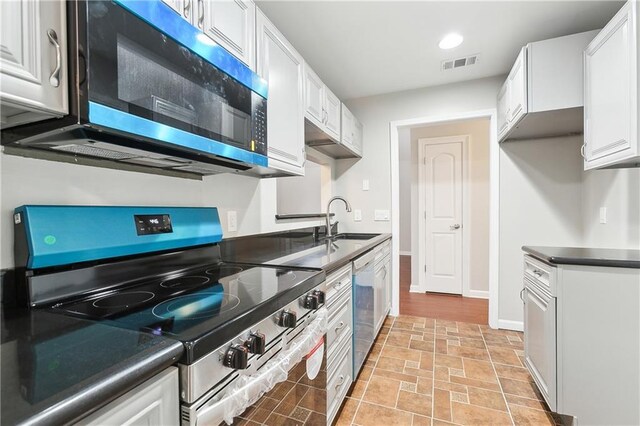 kitchen featuring white cabinetry, sink, and appliances with stainless steel finishes