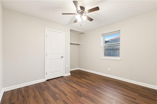 empty room featuring ceiling fan and dark wood-type flooring