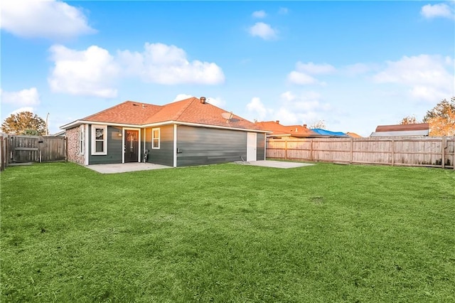 back of property featuring a lawn and a patio