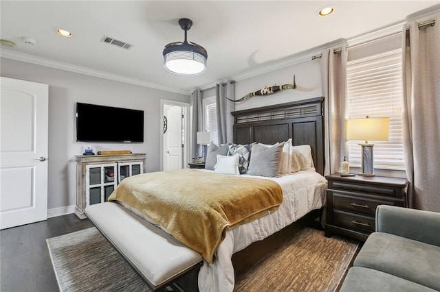 bedroom with crown molding and dark hardwood / wood-style floors