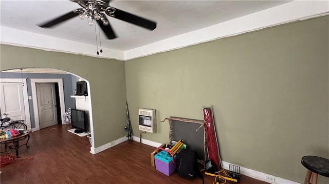 playroom with ceiling fan, dark hardwood / wood-style flooring, and heating unit