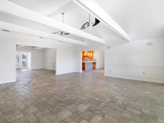 unfurnished living room with vaulted ceiling with beams and ceiling fan