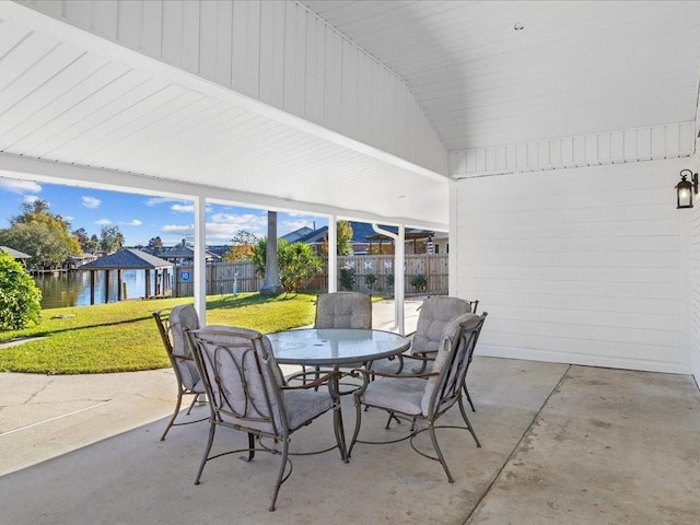 sunroom featuring a water view and a healthy amount of sunlight