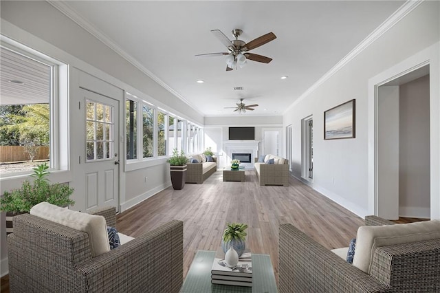 sunroom featuring ceiling fan