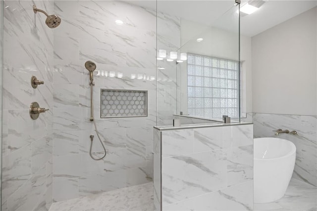 bathroom featuring separate shower and tub and tile walls