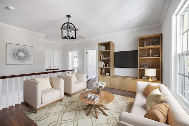 living room with wood-type flooring, an inviting chandelier, and crown molding