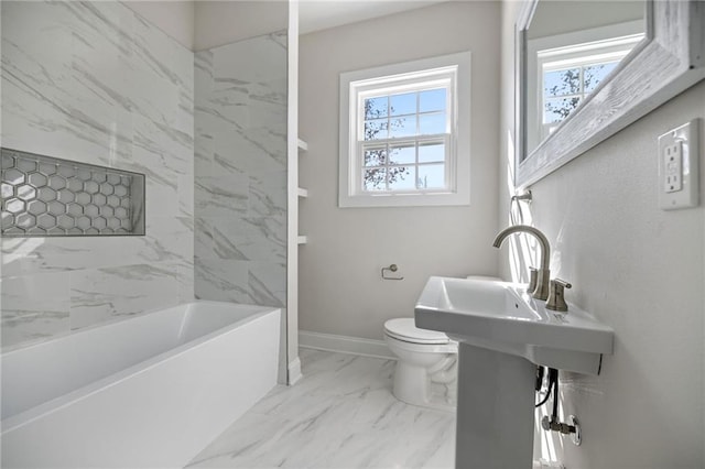 bathroom with tiled shower / bath combo, toilet, and a healthy amount of sunlight