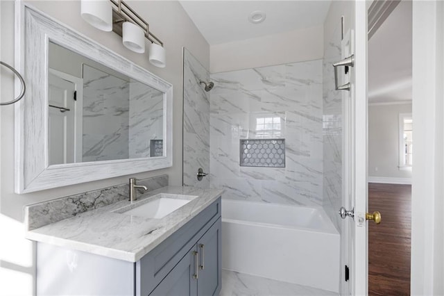 bathroom featuring vanity and tiled shower / bath combo