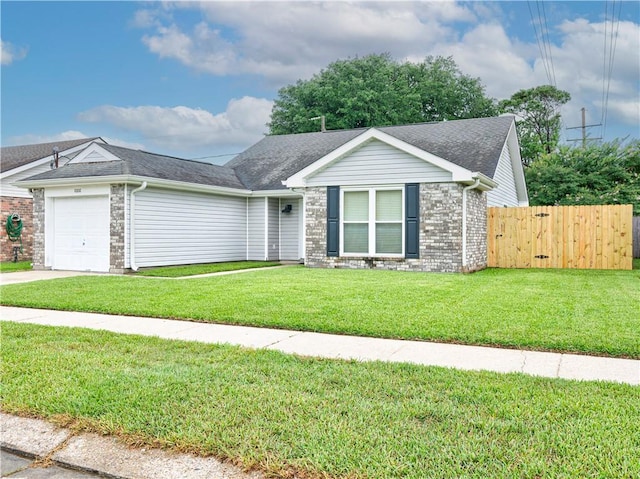 view of front of home with a front lawn and a garage