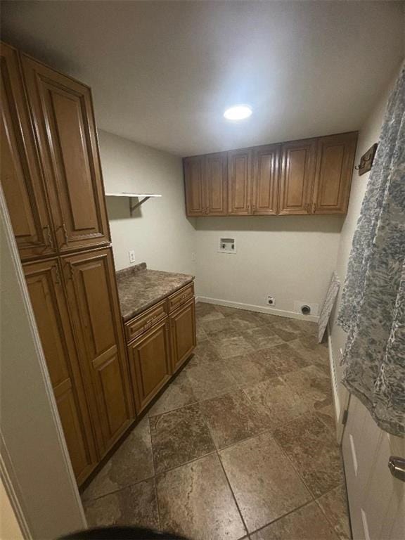 clothes washing area featuring cabinets, hookup for a washing machine, and electric dryer hookup