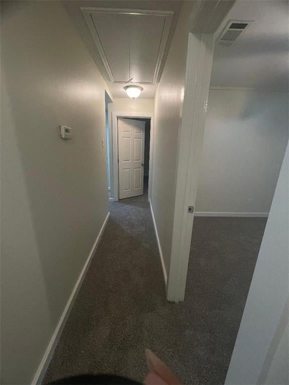 corridor featuring dark carpet