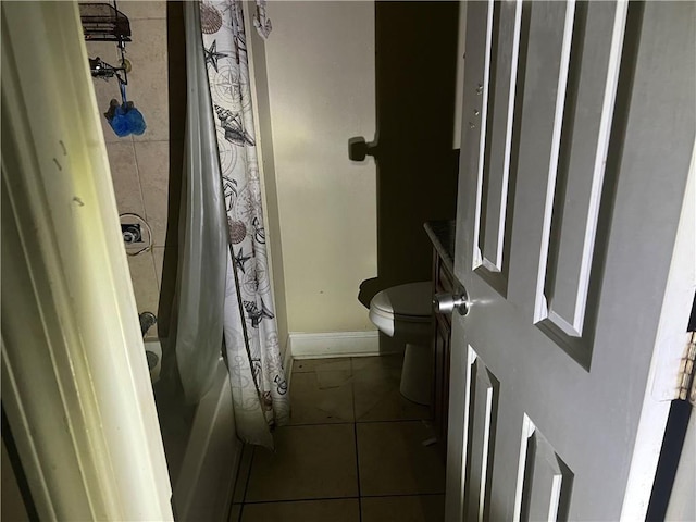 bathroom featuring tile patterned flooring, shower / bathtub combination with curtain, and toilet