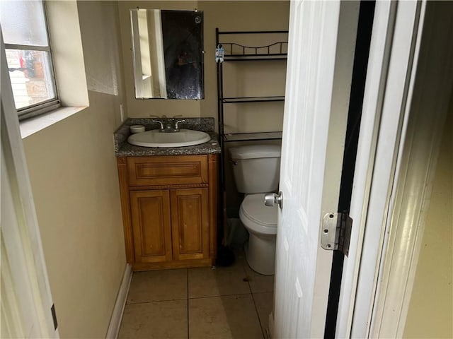 bathroom with tile patterned floors, vanity, and toilet