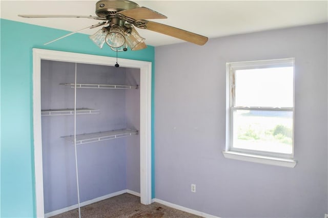 unfurnished bedroom featuring ceiling fan, a closet, and carpet