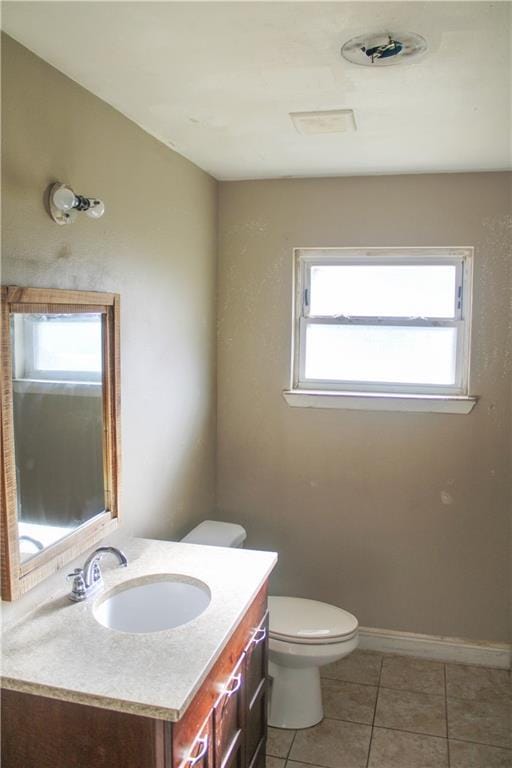 bathroom with tile patterned floors, vanity, and toilet