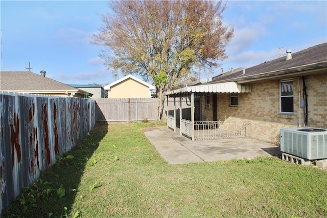 view of yard with central AC unit and a patio