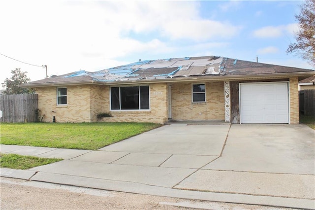 single story home featuring a garage and a front lawn