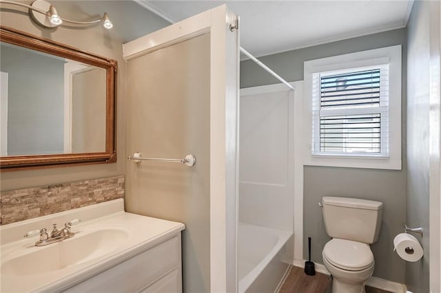 full bathroom featuring washtub / shower combination, hardwood / wood-style floors, vanity, and toilet