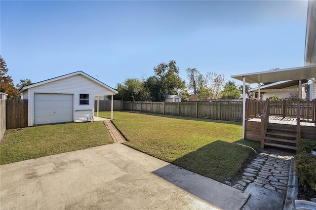 view of yard with a garage, an outdoor structure, and a deck