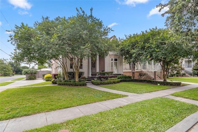 view of property hidden behind natural elements with a front lawn