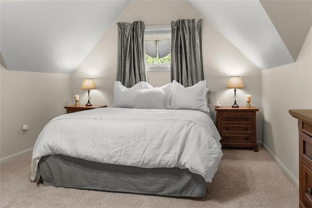 carpeted bedroom with lofted ceiling