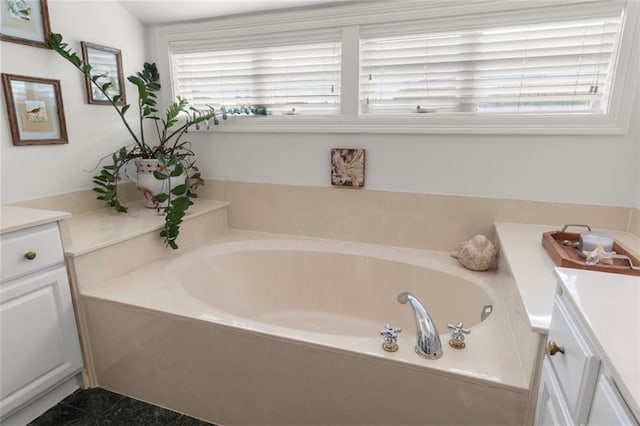 bathroom with vanity and a bath