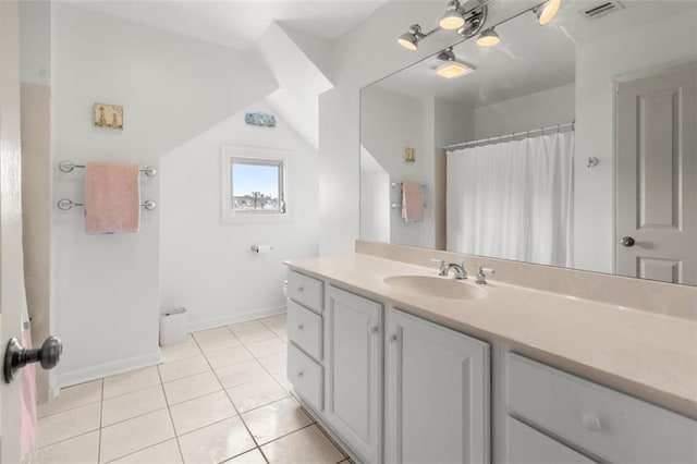 bathroom featuring vaulted ceiling, vanity, and tile patterned flooring