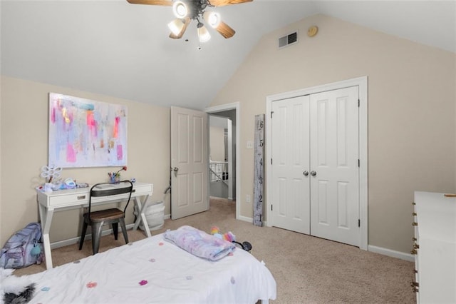 bedroom featuring lofted ceiling, light carpet, ceiling fan, and a closet