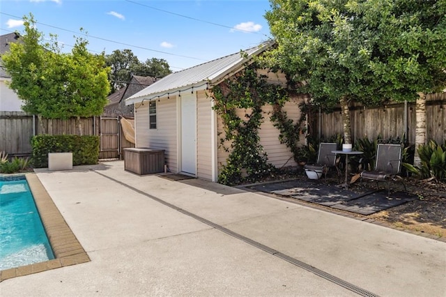 exterior space featuring an outbuilding and a fenced in pool