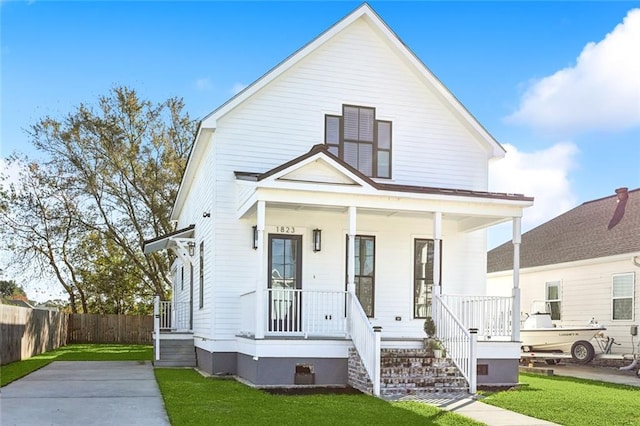 view of front facade with a front lawn and a porch