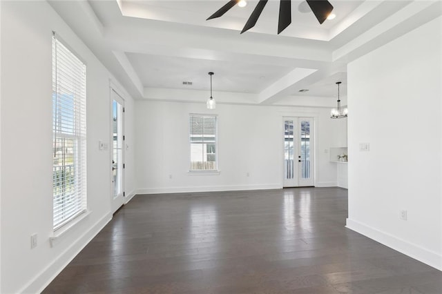 interior space with french doors, a raised ceiling, ceiling fan, and dark wood-type flooring