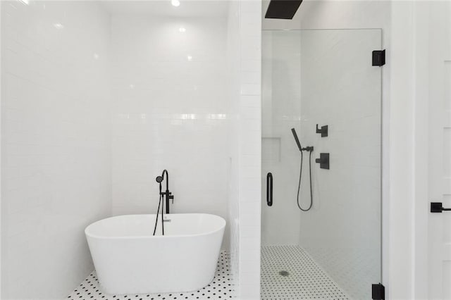 bathroom featuring separate shower and tub