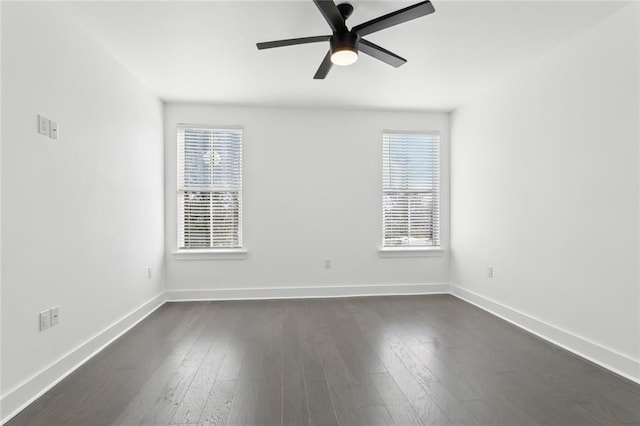 empty room with ceiling fan and dark wood-type flooring