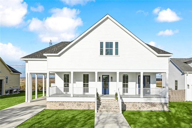 view of front of property featuring a porch, a carport, and a front lawn