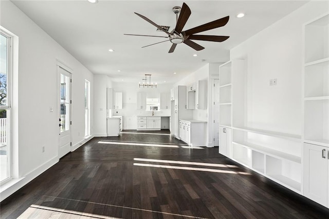 foyer entrance with sink, ceiling fan with notable chandelier, and dark hardwood / wood-style floors